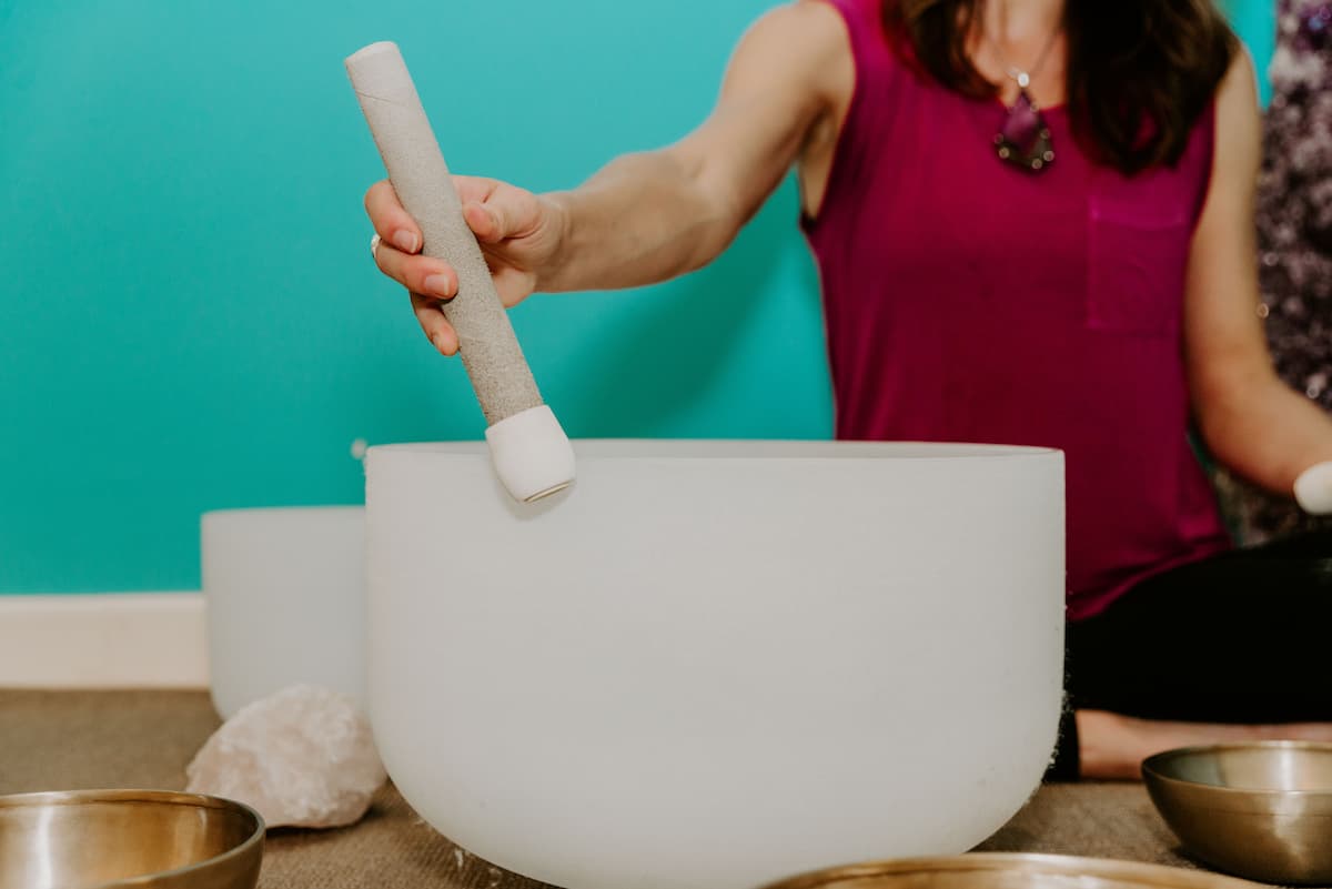 Jamie Bechtold playing crystal singing bowl at The Soundbath Center