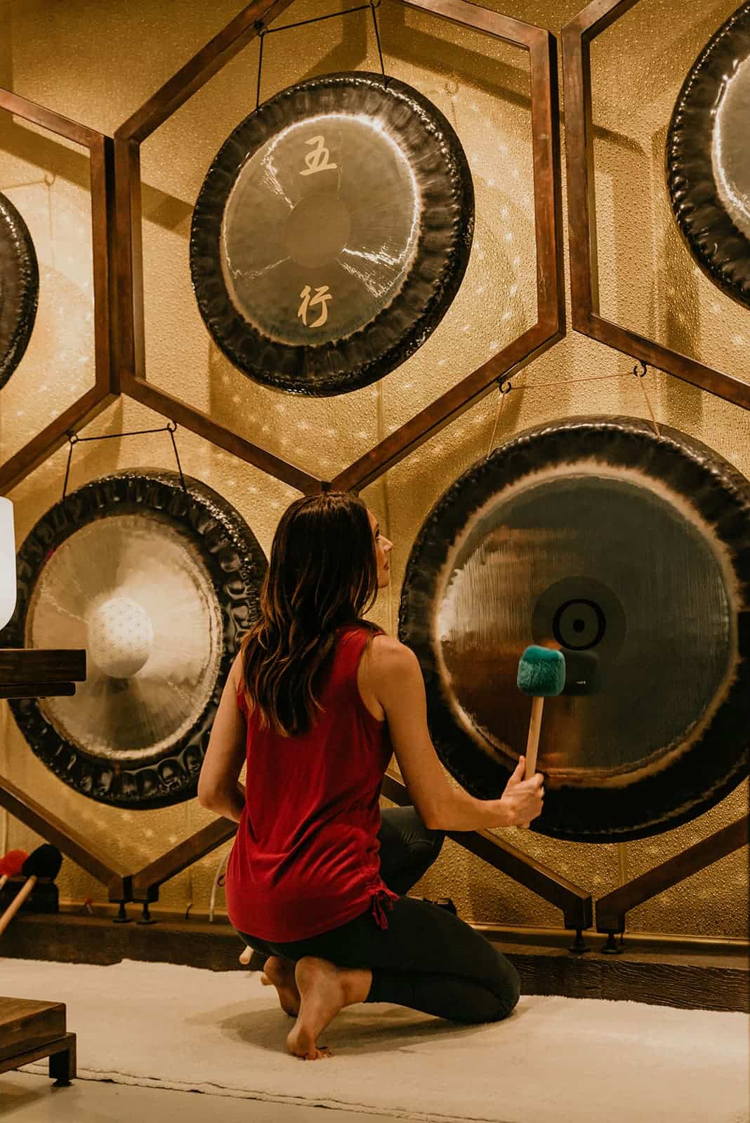 Jamie Bechtold playing a gong at The Soundbath Center