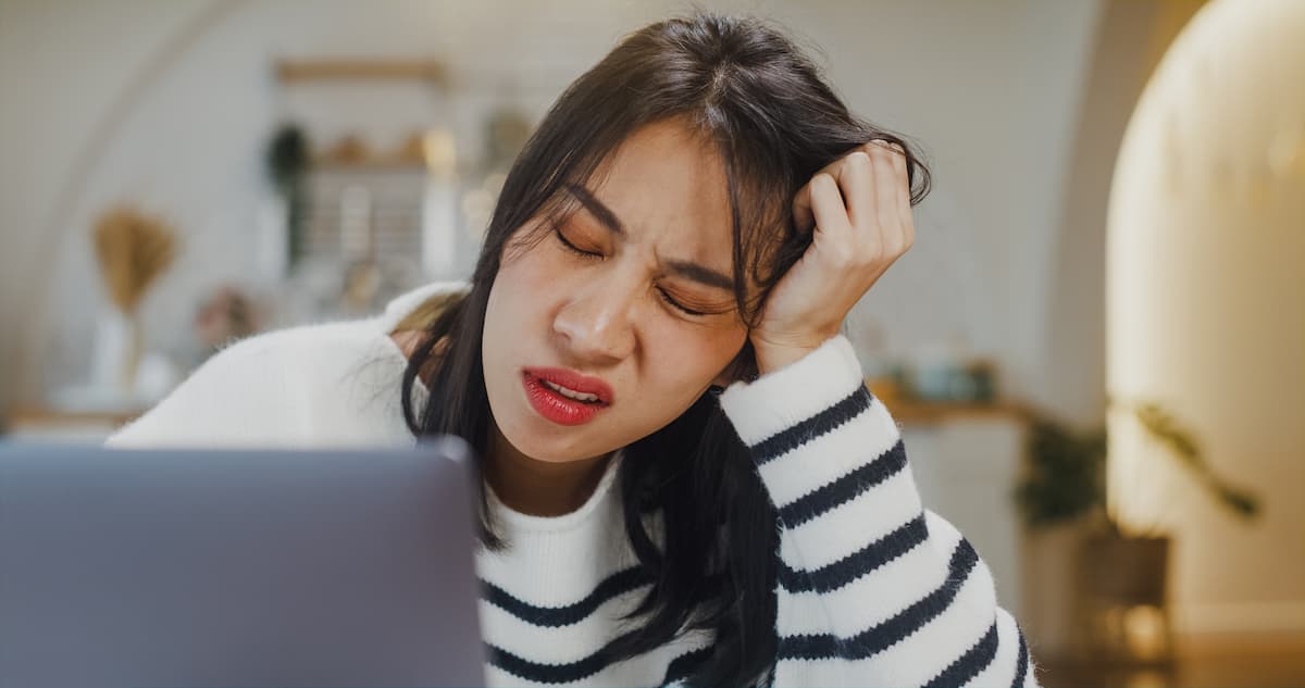 woman looking stressed in front of computer