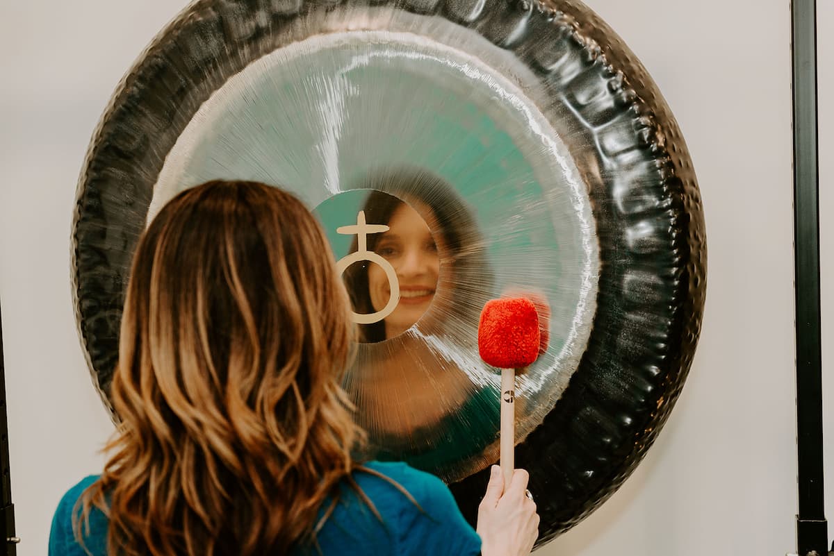 Jamie Bechtold playing Meinl Sonic Energy gong with her reflection in it
