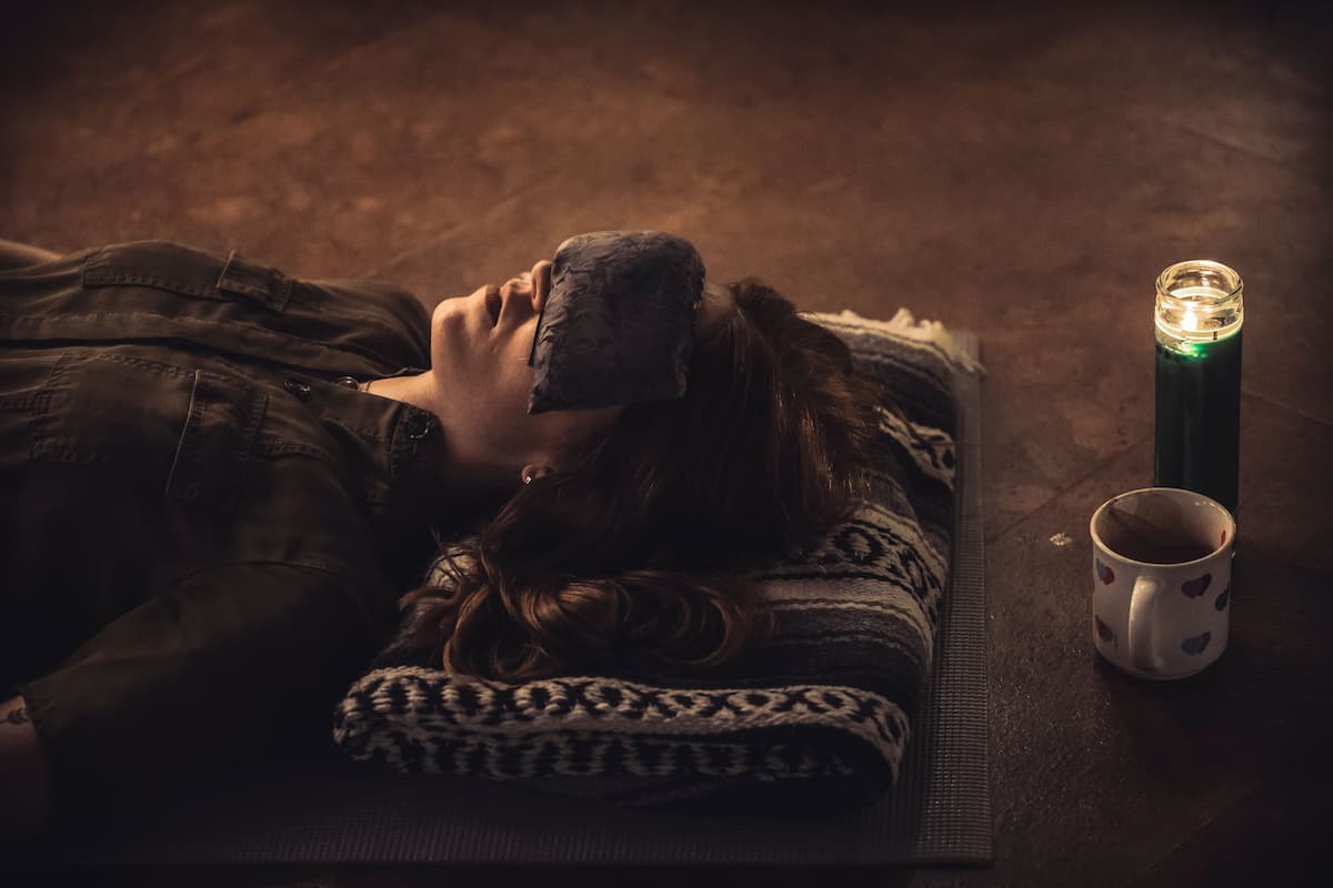Woman receiving a sound bath with eye mask on